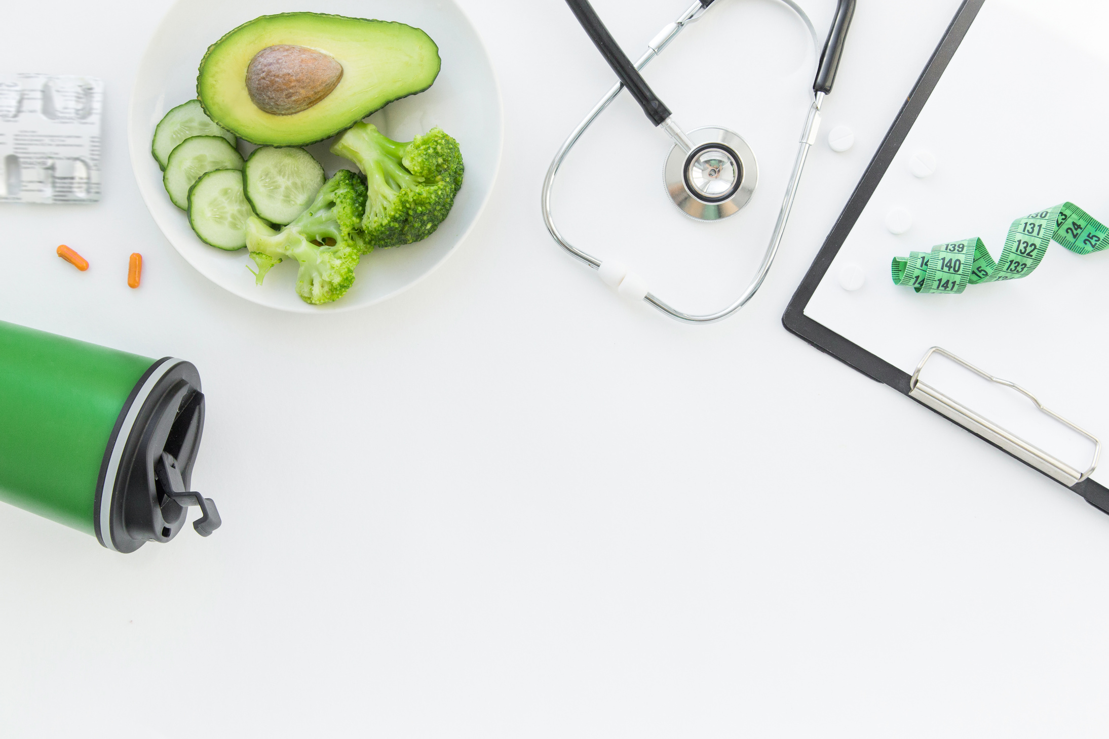 doctor nutritionist table. Healthy and healthy food, broccoli, pickers and avacado. Stethoscope and diet pills. Top View and flatlay, free space for text